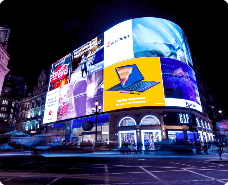 large digital billboard with several brightly lit advertising elements